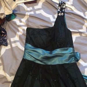 Black dress with green/teal waist strap.